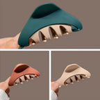 Close-up of green, brown, and beige triangular hair claws