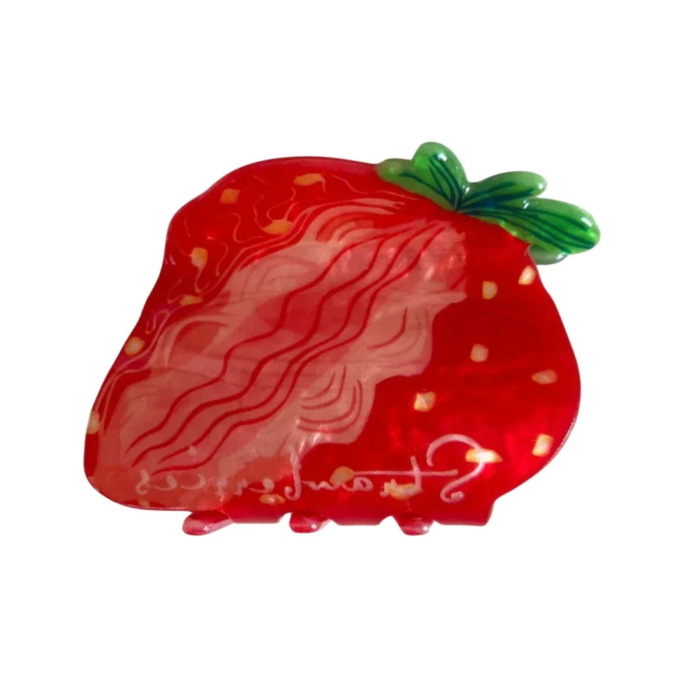 A close-up shot of a strawberry-shaped hair clip. Main image