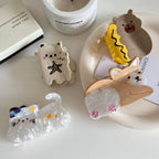 Various animal hair claw clips laid out on a table