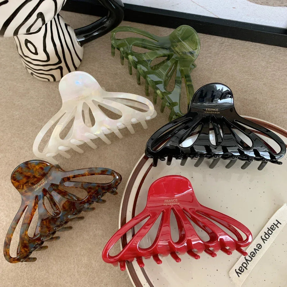 collection of octopus claw hair clips in various colors (green, white, black, brown, red)