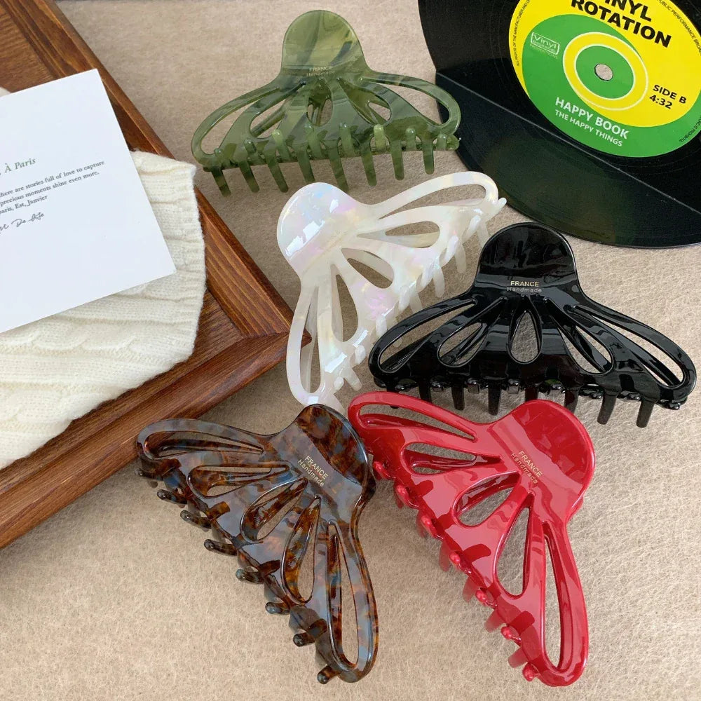 five octopus claw hair clips arranged with decorative items