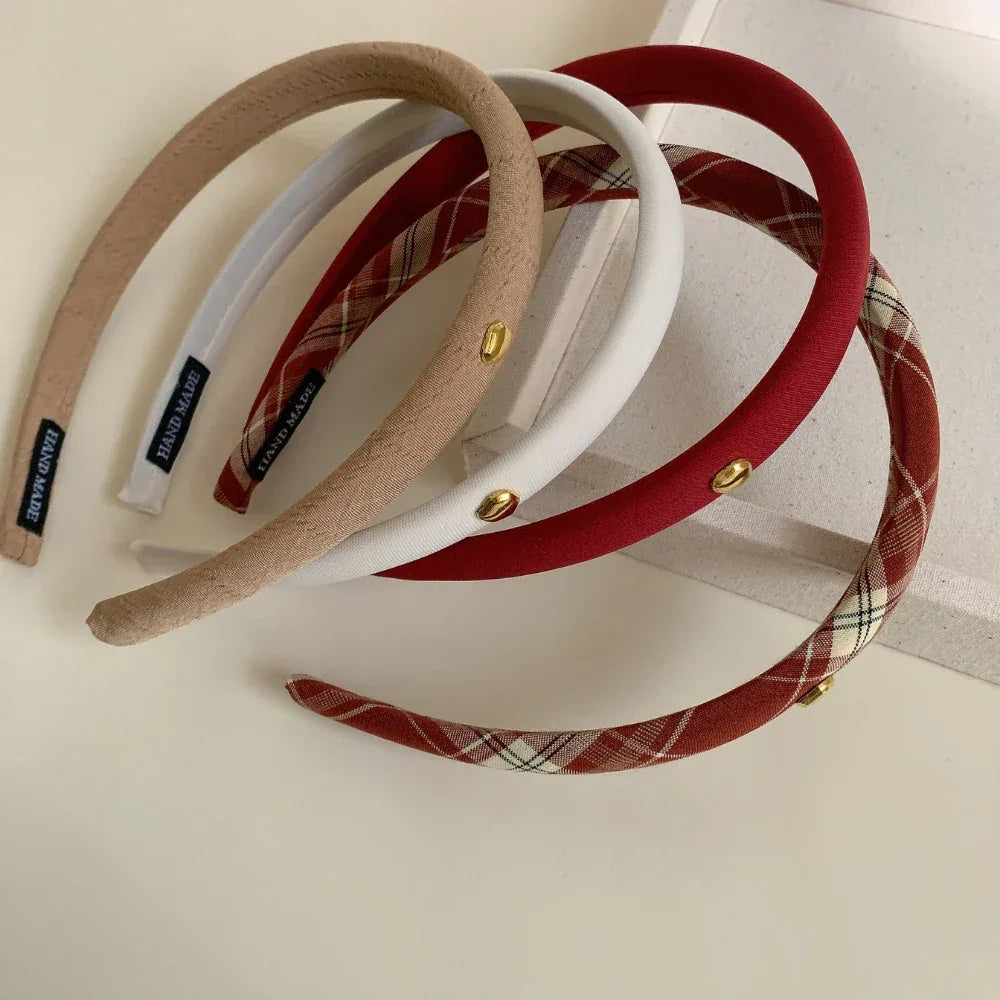Overhead view of padded headbands in red, beige, white, and plaid