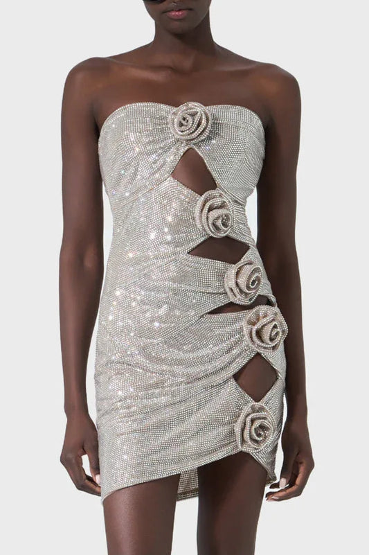 Close-up of a strapless silver mini dress with rose embellishments and cut-out details
