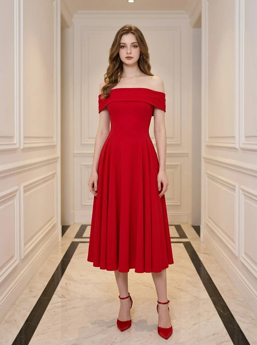 Woman wearing a red off-the-shoulder midi dress with flared skirt and red heels, standing in a hallway.