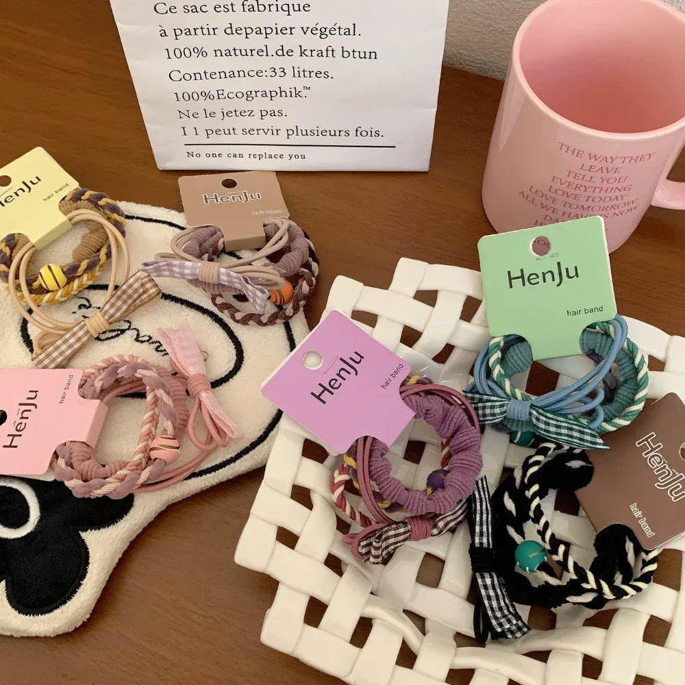 Assortment of hair ties with various patterns and colors displayed on a white tray.