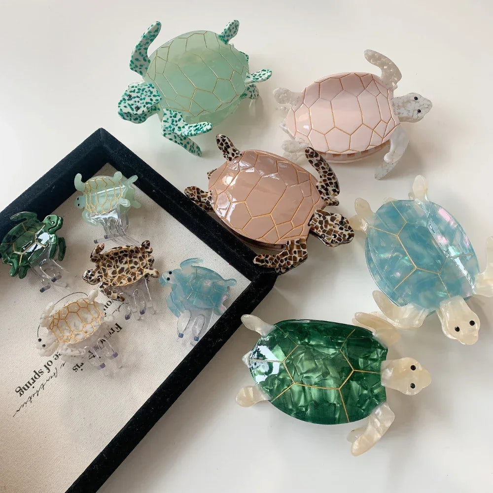 Assortment of translucent and opaque turtle hair clips arranged on a white surface