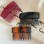 three hair combs: burgundy, black, and tortoiseshell