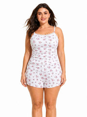 Woman posing in white floral print pajama camisole and shorts