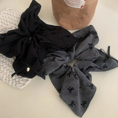 oversized scrunchies in black and grey with bow patterns and lace trim