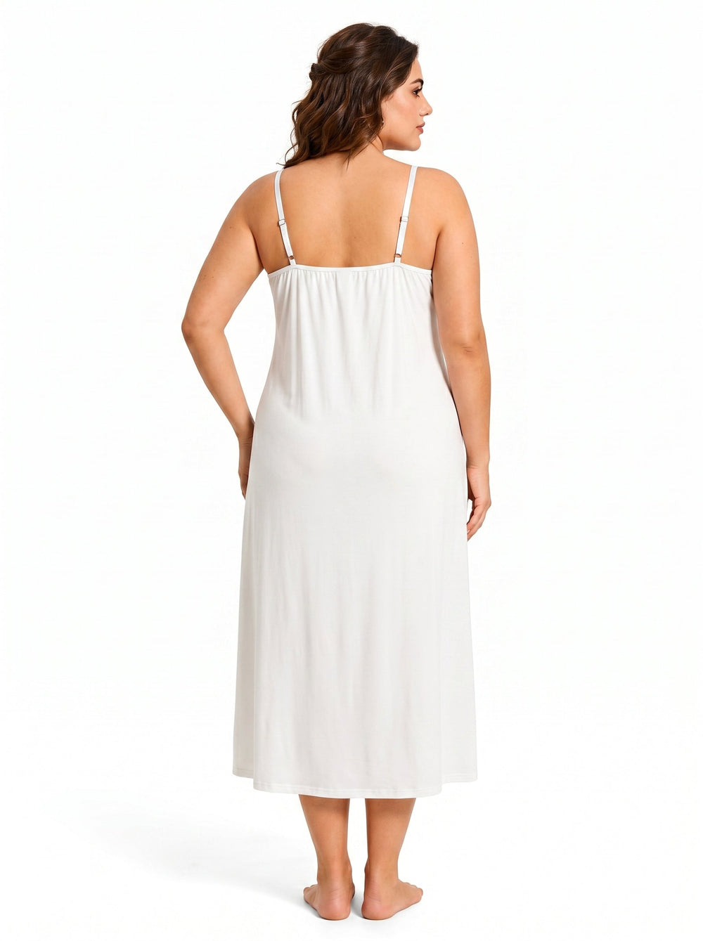 Back view of a woman wearing a white satin slip dress