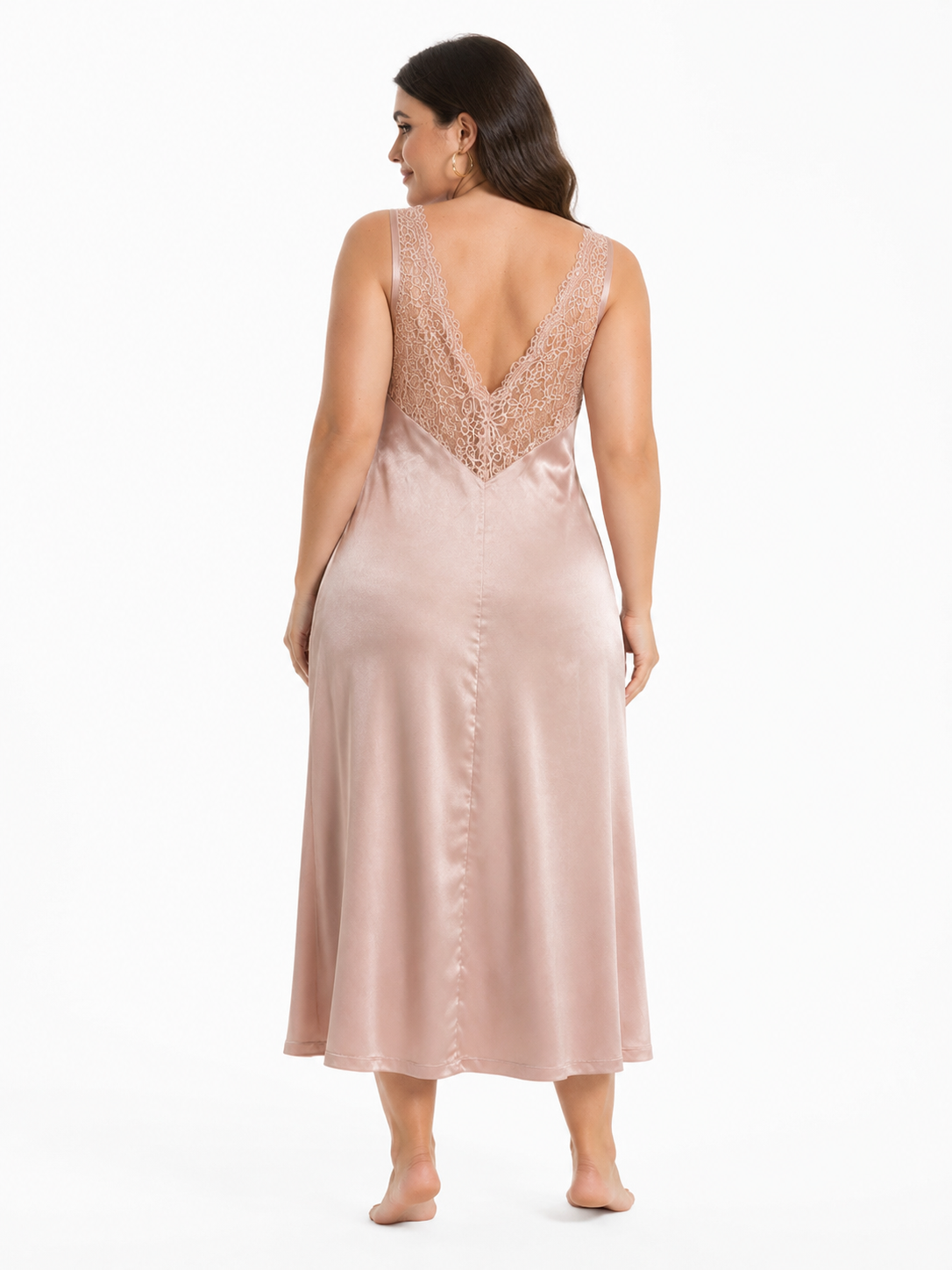 Back view of a woman in a pink satin midi slip dress with a deep V-neck lace detail