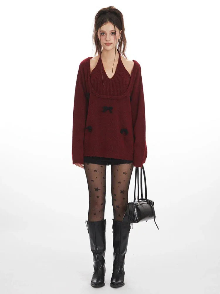 Woman wearing a burgundy layered sweater with black bows, black star-patterned tights, and black boots, holding a black handbag.