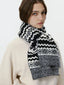 Woman wearing a black and white Fair Isle knit scarf
