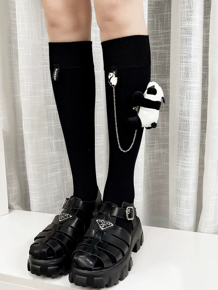 Knee-high black socks with panda charms and chunky platform sandals
