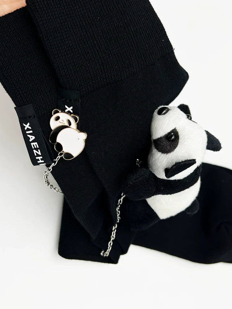 Detailed view of panda charm attached to knee-high black sock