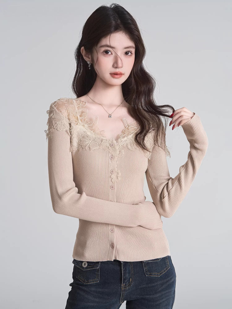 Woman wearing a beige ribbed knit cardigan with lace trim and a v-neck, paired with dark wash jeans.