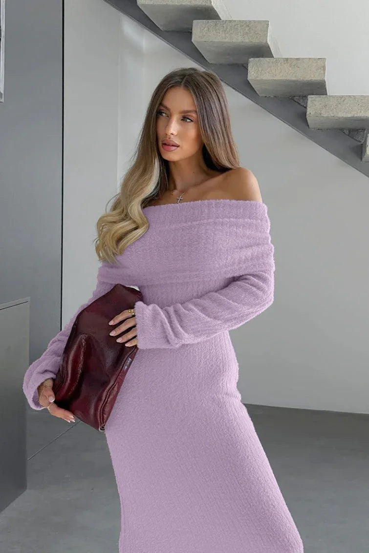 Close-up of a woman's shoulder and chest area wearing a lavender fuzzy off-the-shoulder maxi dress and holding a burgundy handbag.