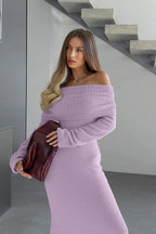 Close-up of a woman's shoulder and chest area wearing a lavender fuzzy off-the-shoulder maxi dress and holding a burgundy handbag.