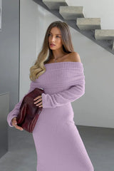 Close-up of a woman's shoulder and chest area wearing a lavender fuzzy off-the-shoulder maxi dress and holding a burgundy handbag.