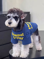 Dog in a blue t-shirt with yellow text
