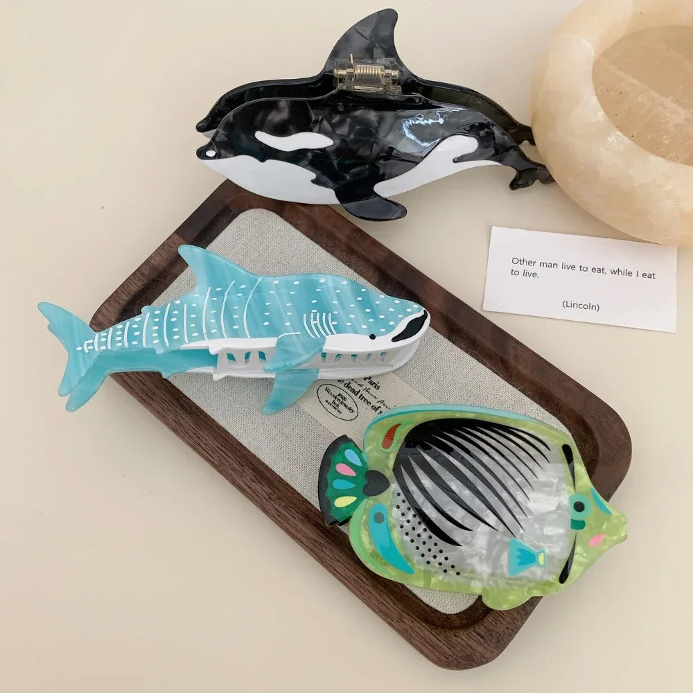 Orca and whale shark hair clips on a tray with a decorative bowl