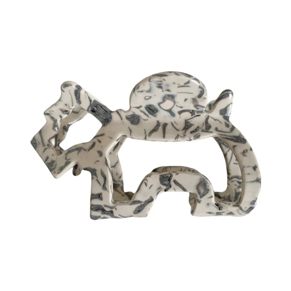 A single elephant-shaped hair claw clip with a marbled black and white pattern, isolated on a white background.