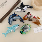 Assortment of animal-shaped hair clips including a koi fish, dolphin, orca, whale shark, and angelfish