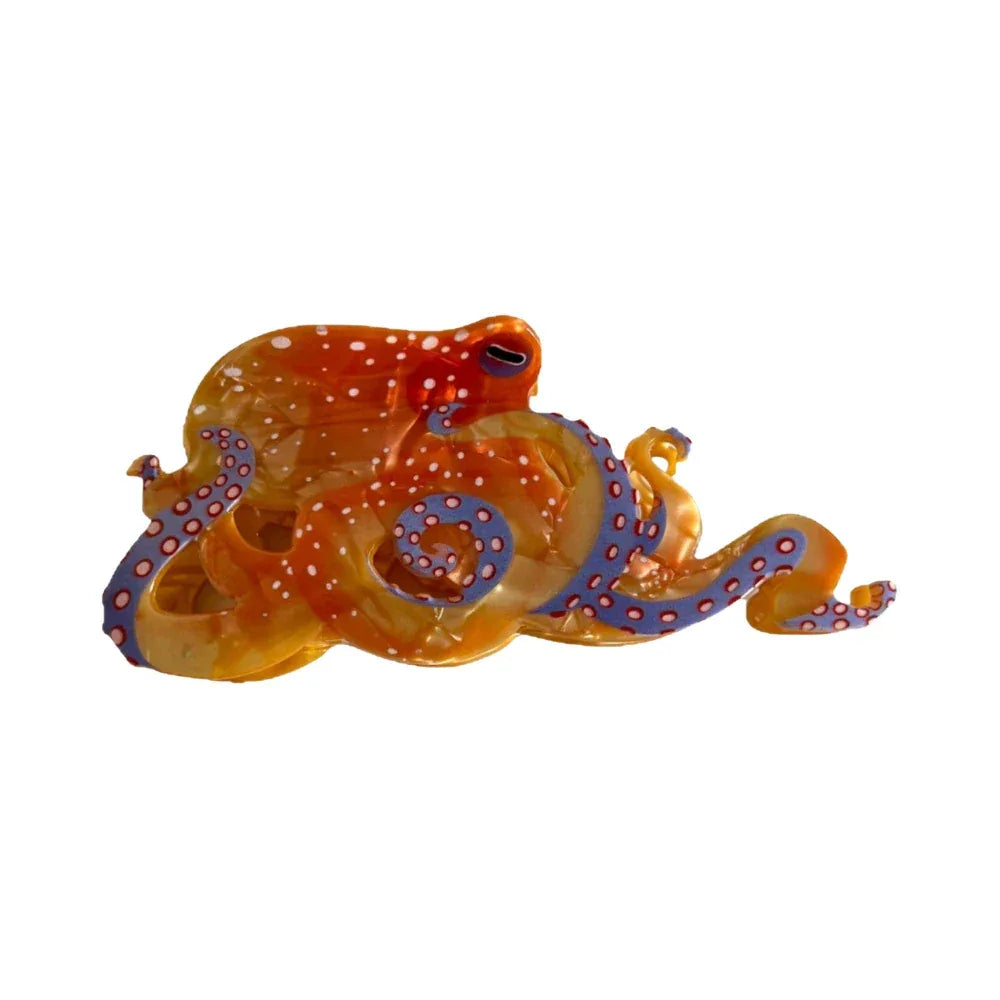 A translucent orange octopus-shaped hair clip with white polka dots and blue tentacle details, isolated on a white background. Main image