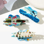 Collection of three cloud-shaped hair claws featuring ocean and beach themes