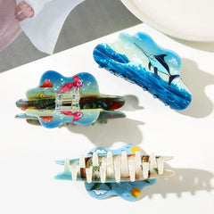 Collection of three cloud-shaped hair claws featuring ocean and beach themes
