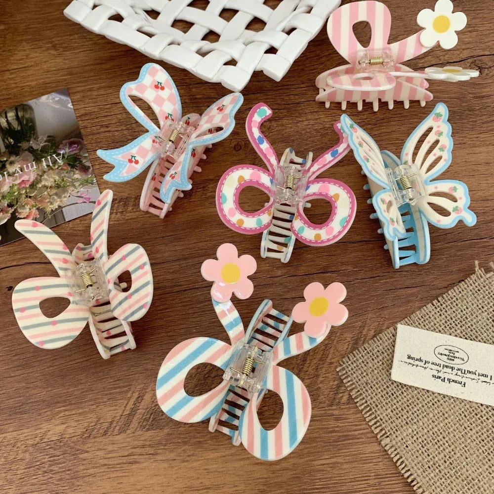 Collection of decorative hair clips including bows and butterflies in pastel colors