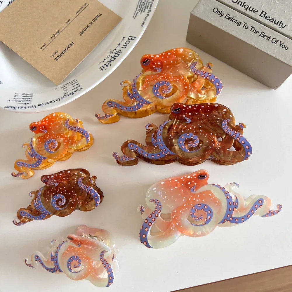 An assortment of octopus-shaped hair clips, showcasing translucent materials in orange, brown, and pinkish-white tones with distinctive white polka dots and blue tentacle patterns.