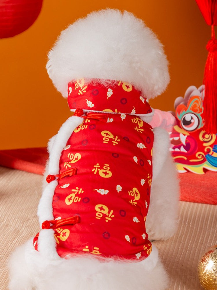 Back view of a white Bichon Frise dog wearing a red and white traditional Chinese style vest with gold cloud and character prints.