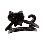 A black cat-shaped hair claw clip with a bow tie detail.
