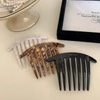 three hair combs in various colors displayed on a light background