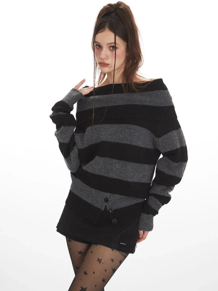 Model wearing a grey and black striped sweater styled off-the-shoulder, black shorts, black tights with stars, and black boots, touching her shoulder.