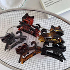 A collection of cat-shaped hair claw clips in various tortoiseshell patterns.