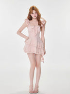Full body shot of a woman in a pink tiered dress