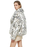 back view of a woman wearing a dalmatian print faux fur cropped jacket