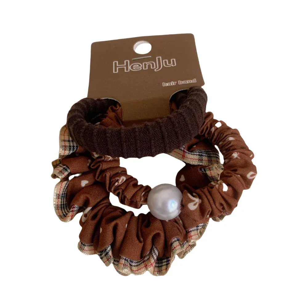 Brown scrunchie with plaid pattern and pearl embellishment Main image