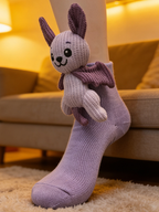 Close-up of a light purple ankle sock with a plush bat character attached to the cuff, worn on a person's foot.