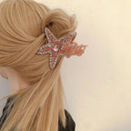 A blonde woman wearing a pink rhinestone-embellished starfish hair claw clip in her updo