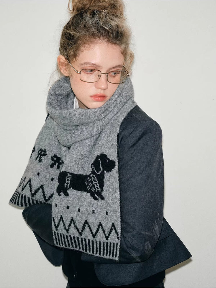 Close-up of a gray knit scarf with a dachshund pattern.