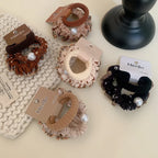 Collection of scrunchies with various patterns and pearl details