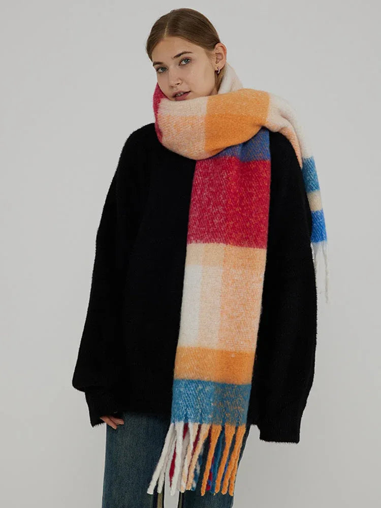 Woman wearing a black sweater and a colorful plaid scarf