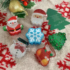 Collection of glittery Christmas-themed hair claw clips including Santa, snowman, Christmas tree, snowflake, and stocking