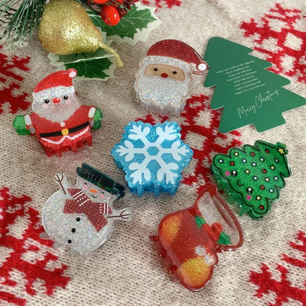 Collection of glittery Christmas-themed hair claw clips including Santa, snowman, Christmas tree, snowflake, and stocking