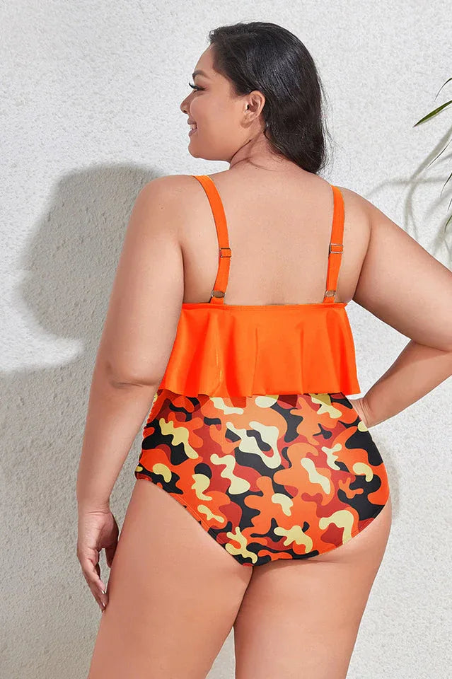 Back view of a plus-size woman in an orange ruffle tankini top with camouflage bottoms