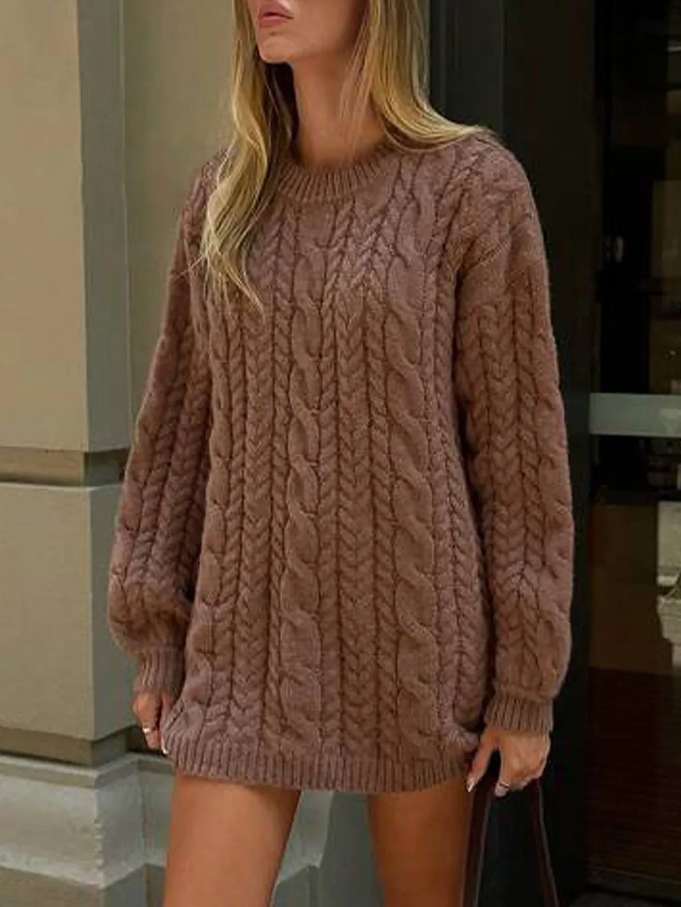 Front view of a woman in a brown cable knit sweater dress with long sleeves.