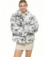 smiling woman wearing a dalmatian print faux fur cropped jacket